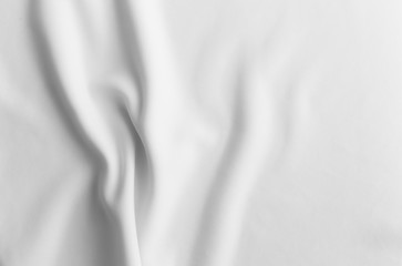 White abstract wavy clothes background. fabric texture