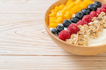 homemade yogurt bowl with raspberry, blueberry, mango and granola