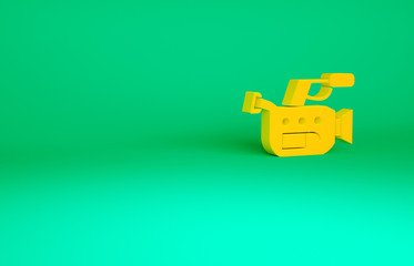 Orange Cinema camera icon isolated on green background. Video camera. Movie sign. Film projector. Minimalism concept. 3d illustration 3D render.