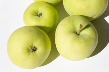 Close up green fresh autumn garden apples on white background