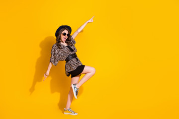 Full length photo of positive cheerful crazy girl dance raise index finger copyspace wear retro style outfit sneakers isolated over shine color background