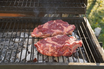 Group grilled ribeye beef steaks on the grill outdoor, background. barbecue season concept, bbq copy space, summer