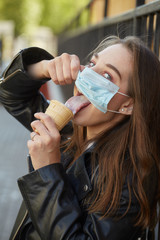 girl eats in mask