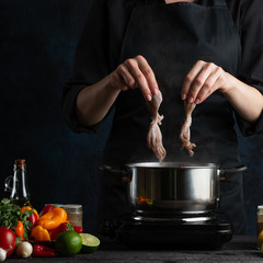 Professional chef cook octopus seafood, on a background of vegetables, cookbook of recipes, gastronomy