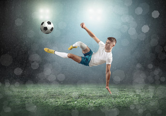 Fototapeta na wymiar Soccer player on a football field in dynamic action 