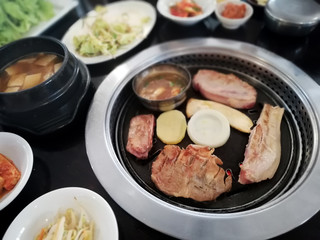 Korean BBQ pork on the onion, potato, mushroom grilled and Pickled Vegetables.