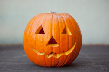 Halloween pumpkin head jack lantern on wooden background