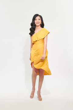 Portrait of a beautiful young woman in yellow dress and turn around.
