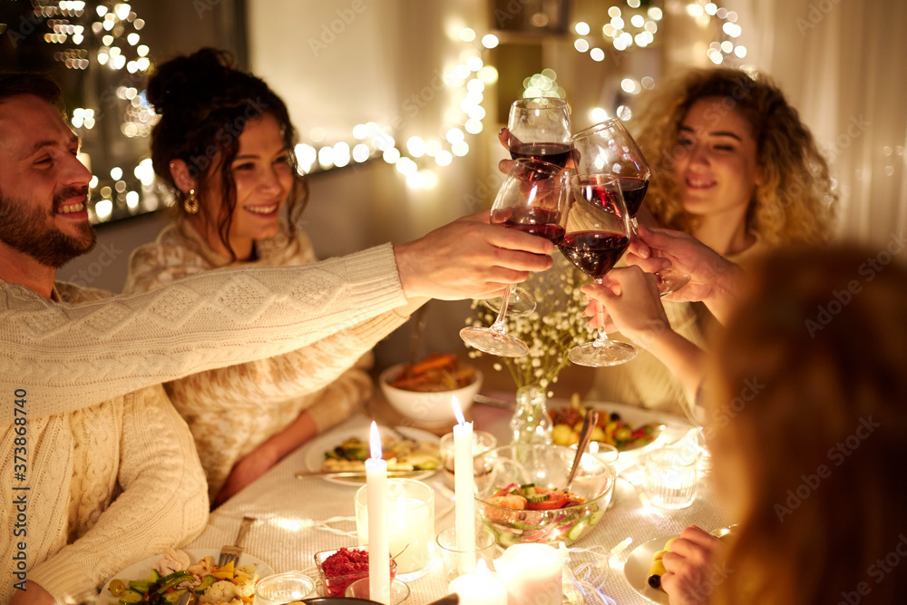 Poster holidays, celebration and people concept - happy friends having christmas dinner at home drinking no