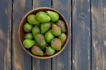 fresh pears in a wooden bowl