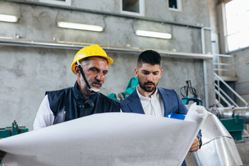 industry worker and supervisor talking, indoor at the gas plant