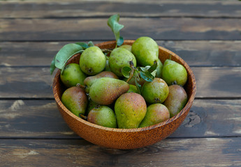 fresh pears in a wooden bowl