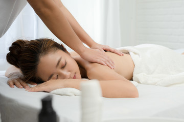 Fototapeta na wymiar Beautiful Asian woman relaxing with hand massage at beauty spa.