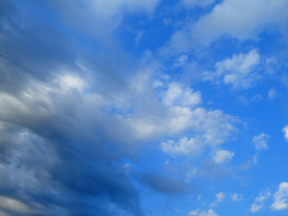 The blue cloudy sky with white  and gray clouds background and texture