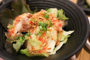 cabbage spicy salad on black bowl
