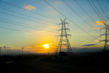 high-voltage power lines at sunset,high voltage electric transmission tower
