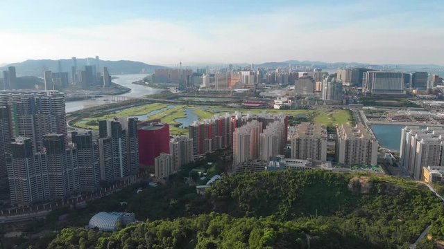 Rotating tilting aerial of Macau cityscape from Coloane mountain