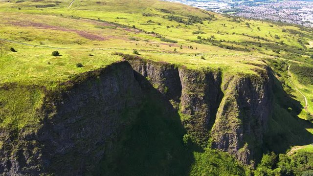 Tilting aerial reveal shot of Cavehill Country Park in Belfast