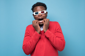 African young man in 3-d glasses watching horror movies