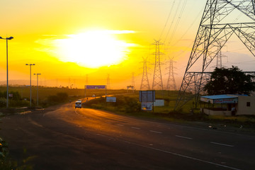 high-voltage power lines at sunset,high voltage electric transmission tower