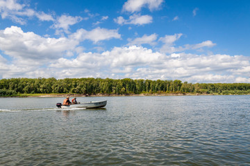 Fototapeta na wymiar Fishermen ride the ob river in Siberia in the middle of summer