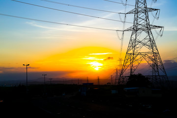 Fototapeta na wymiar high-voltage power lines at sunset,high voltage electric transmission tower
