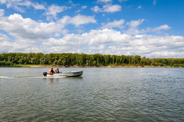 Fototapeta na wymiar Fishermen ride the ob river in Siberia in the middle of summer