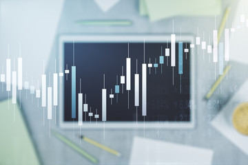 Abstract creative financial graph and modern digital tablet on desktop on background, top view, financial and trading concept. Multiexposure