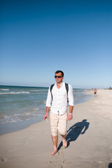 young man walking on the beach