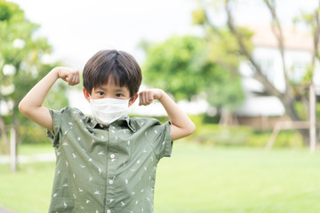 a strong boy is play in the garden with mask.