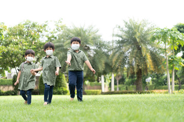 3 brothers are walking and playing in the garden in the evening..