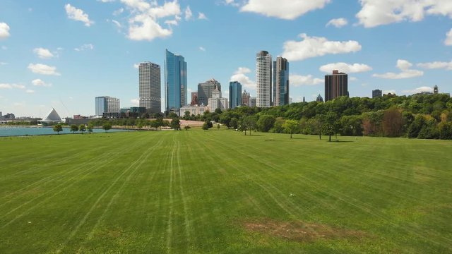 Milwaukee Wisconsin Aerial Footage. Downtown Skyline of the city on a bright summer day. Happy atmosphere at the park. The art museum in the corner.