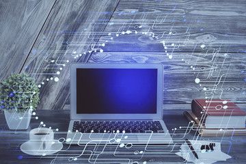 Double exposure of desktop computer and technology theme hologram. Concept of software development.
