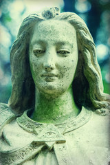 Angel of death. Sad angel as symbol of pain, fear and end of life. Ancient stone statue. Horizontal image.