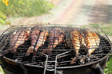 Fresh sea fishes on the grill outdoors.