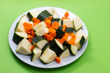 fresh zucchini with carrot on white plate