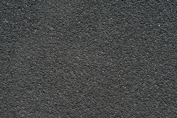 Texture of a rubber treadmill. Black floor in the stadium close up.