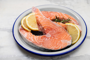 fresh raw salmon on the dish on ceramic background