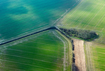 Aerial view of patchwork of green fields in Cambridgeshire farmland