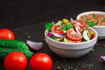Vegetarian summer salad with beans in tomato and microgreen on the table,