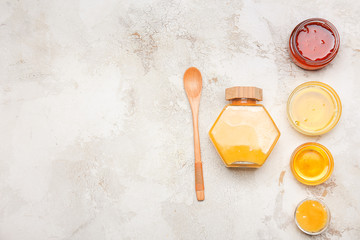 Obraz na płótnie Canvas Assortment of tasty honey on grey background