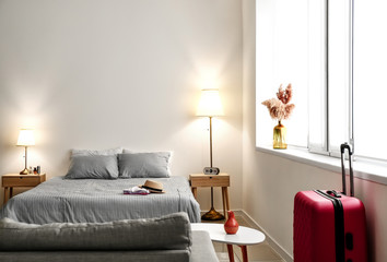 Interior of modern hotel room with glowing lamps