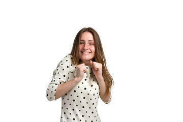 A young woman with long brown hair and a white polka-dot dress.