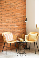 Stylish interior of living room with table and chairs