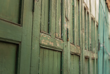 Green vintage wooden door old ancient traditional of home asia. Retro architecture exterior building. Selective focus.