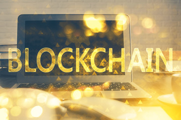 Multi exposure of blockchain theme hologram and table with computer background. Concept of bitcoin...