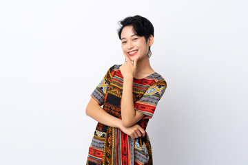 Young Asian girl with a colorful dress over isolated white background smiling