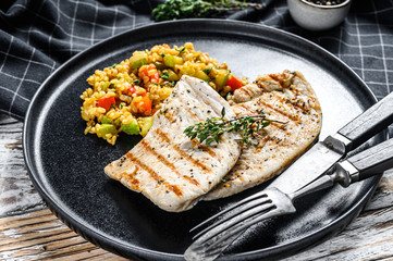 Grilled Turkey breast Steaks with quinoa salad. White background. Top view