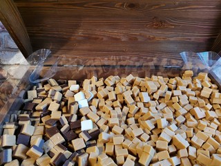 different kinds of toffees lie in a wooden chest