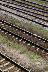 Fototapeta na wymiar Railway top view background. Train transport industry. Vertical rail track texture. Good and cheap way of transportation for cargo. Old railroad wooden tie. Track ballast gravel made of crushed stone.